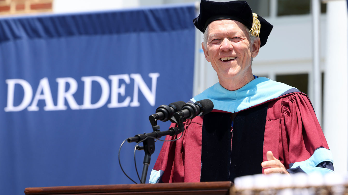 Dean Beardsley speaking in front of Darden sign