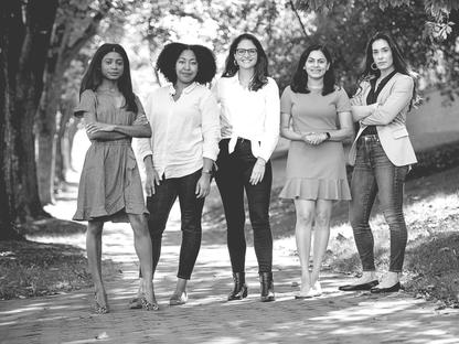 women at darden power pose with transparency