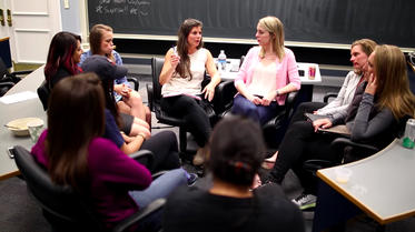 darden mba women sitting in a circle in a classroom