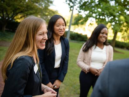 career coach and two students talking outside