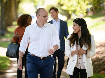 Students walking outside talking with Professor Sasa Zorc