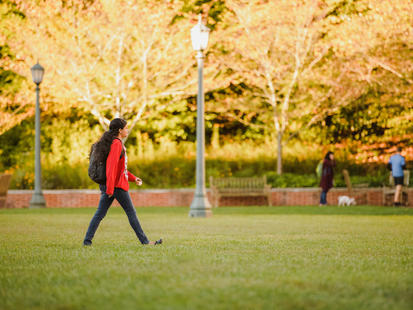 student walking across grounds