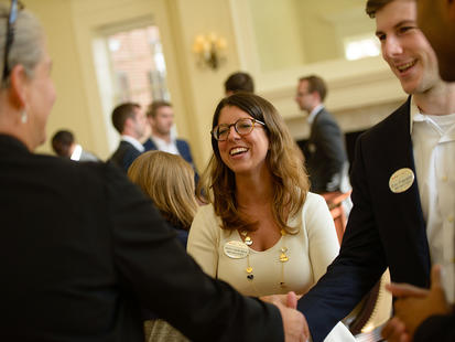 Two students speak with a recruiter