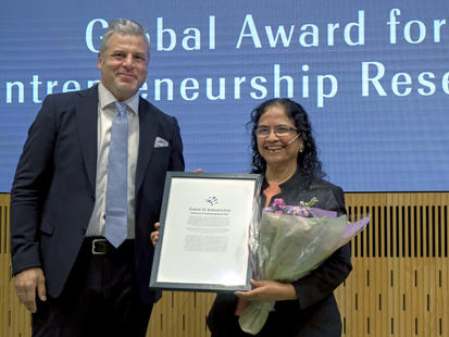 Saras Sarasvathy receiving an award in 2022