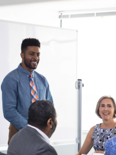 Darden grads in a meeting room.