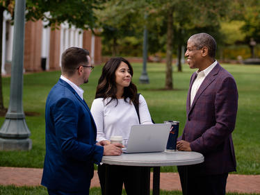 Darden Professor Martin Davidson with students outside