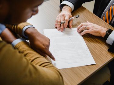 a student and a staff member review a resume