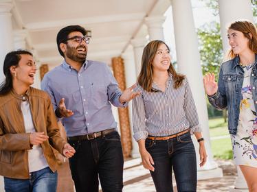 four students walking and laughing