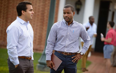 Two UVA Darden students speaking together outdoors