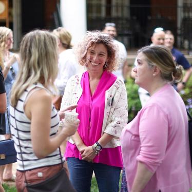 three women talking and standing outside