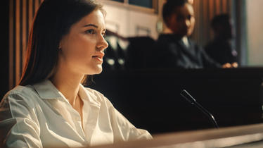 Witness in court with judge out of focus in background
