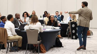Darden Professor in front of school leaders