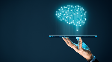 Machine learning image of hand holding up computer with digital brain projected above